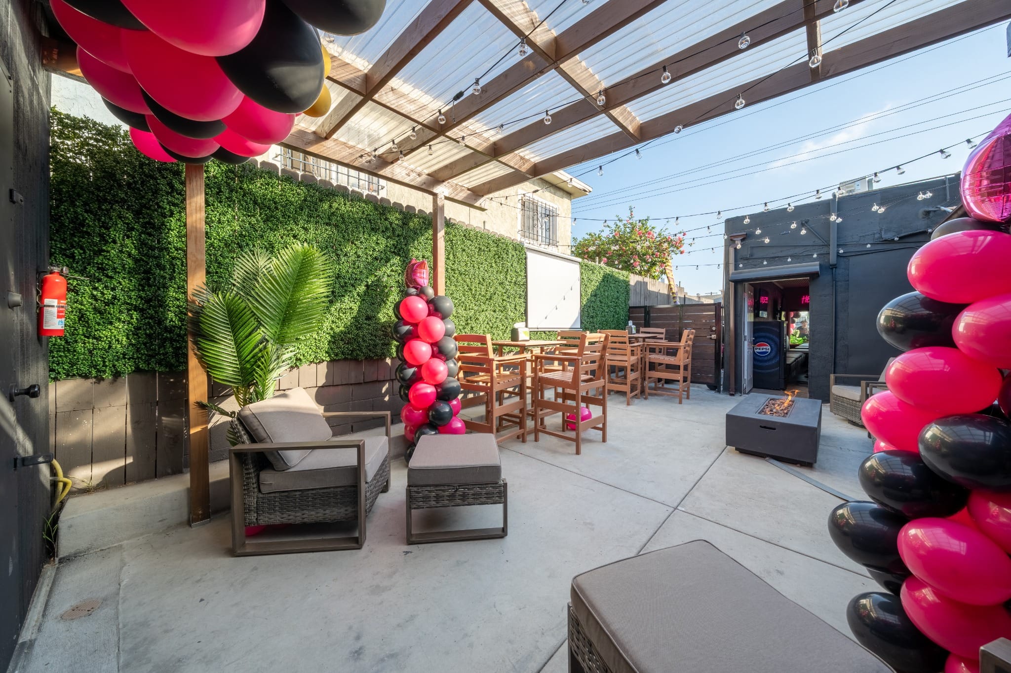 Pink and black balloons framing the patio